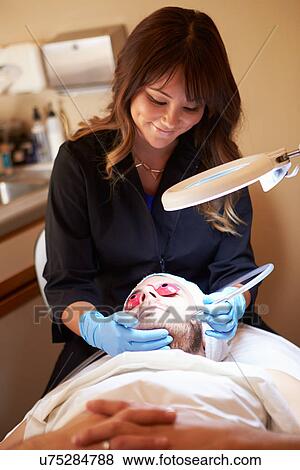 Man Having Dermo Abrasion Cosmetic Treatment At Spa View Large Photo Image Stock Photo - Man Having Dermo Abrasion Cosmetic Treatment At Spa. Fotosearch