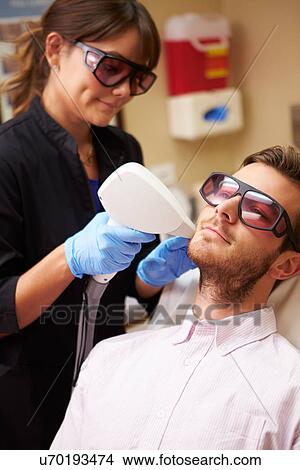 Man Having Laser Treatment At Beauty Clinic View Large Photo Image Picture - Man Having Laser Treatment At Beauty Clinic. Fotosearch