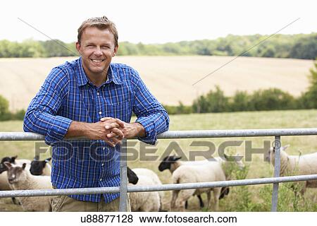 Stock Photo - Man leaning on country fence. Fotosearch