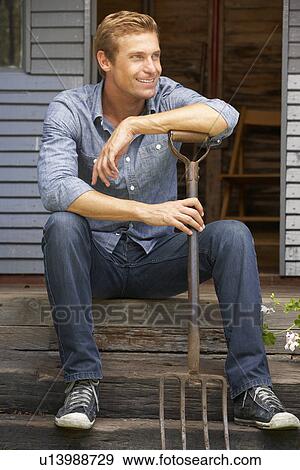 Man leaning on garden fork View Large Photo Image Stock Photo - Man leaning on garden fork. Fotosearch