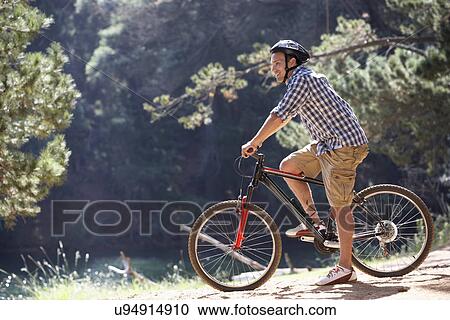 Man on country bike ride View Large Photo Image Stock Image - Man on country bike ride. Fotosearch