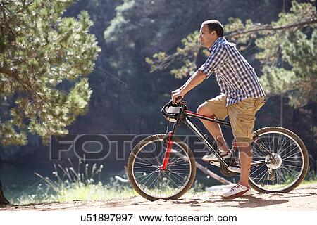 Man on country bike ride View Large Photo Image Stock Photo - Man on country bike ride. Fotosearch