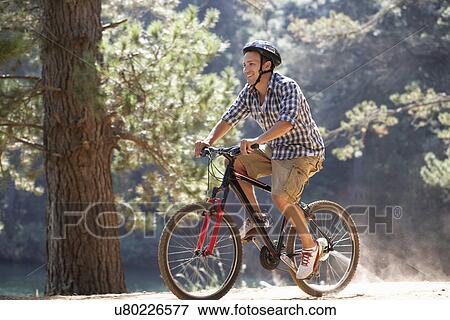 Stock Photo - Man on country bike ride. Fotosearch