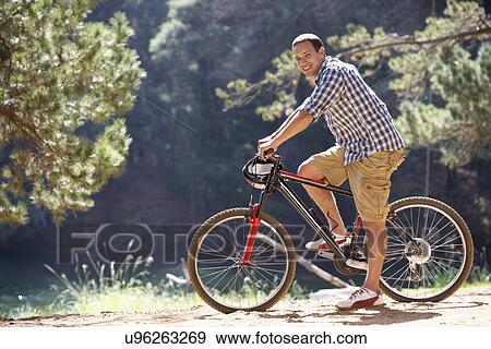 Man on country bike ride View Large Photo Image Stock Photo - Man on country bike ride. Fotosearch