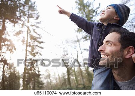 Picture - Man On Roof Terrace Using Digital Tablet. Fotosearch