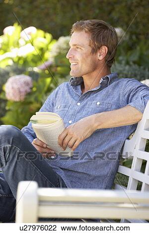 Man reading in garden View Large Photo Image Stock Image - Man reading in garden. Fotosearch