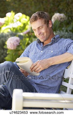 Man reading in garden View Large Photo Image Stock Image - Man reading in garden. Fotosearch