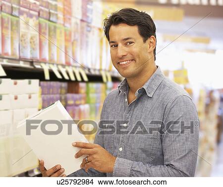Man shopping in supermarket View Large Photo Image Picture - Man shopping in supermarket. Fotosearch