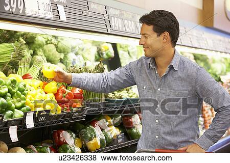 Man shopping in supermarket View Large Photo Image Stock Photo - Man shopping in supermarket. Fotosearch