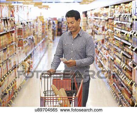 Man shopping in supermarket View Large Photo Image Stock Photography - Man shopping in supermarket. Fotosearch