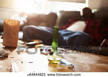 Man Slumped On Sofa With Drug Paraphernalia In Foreground View Large Photo Image Stock Image - Man Slumped On Sofa With Drug Paraphernalia In Foreground. Fotosearch