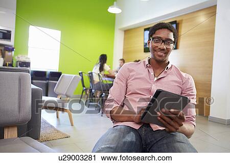 Stock Image - Man Taking A Break Working In Design Studio . Fotosearch