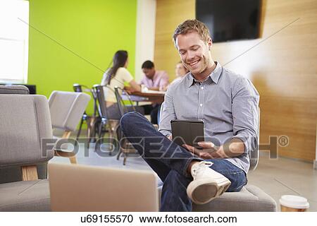Stock Image - Man Taking A Break Working In Design Studio . Fotosearch