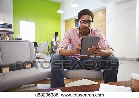 Stock Photograph - Man Taking A Break Working In Design Studio . Fotosearch