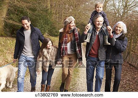 Stock Photo - Man Taking Dog For Walk On City Street. Fotosearch