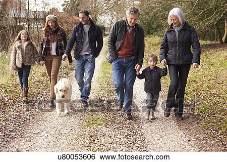 Stock Photograph - Man Taking Dog For Walk On City Street. Fotosearch