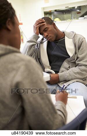 Man Talking To Counsellor Who Takes Notes View Large Photo Image Stock Photo - Man Talking To Counsellor Who Takes Notes. Fotosearch