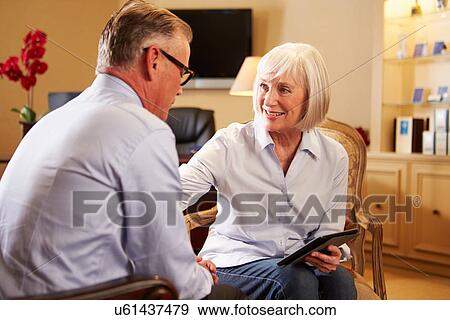 Stock Photo - Man Talking To Female Counsellor Using Digital Tablet. Fotosearch