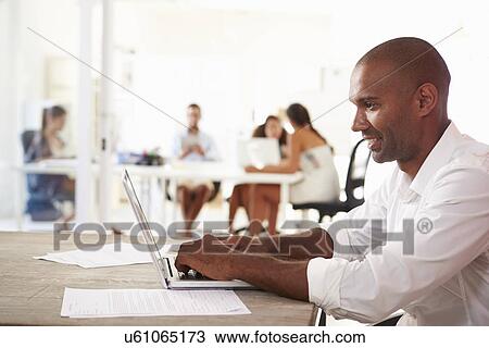 Man Using Laptop In Modern Office Of Start Up Business View Large Photo Image Stock Image - Man Using Laptop In Modern Office Of Start Up Business. Fotosearch