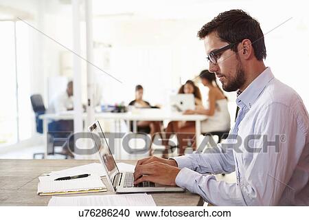 Man Using Laptop In Modern Office Of Start Up Business View Large Photo Image Stock Image - Man Using Laptop In Modern Office Of Start Up Business. Fotosearch