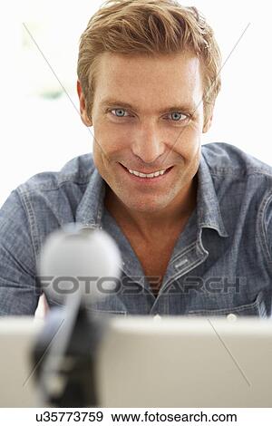 Man using skype View Large Photo Image Stock Photo - Man using skype. Fotosearch