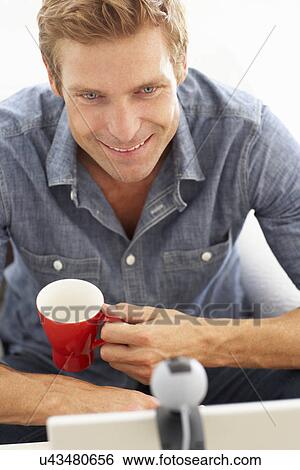 Stock Photograph - Man using skype. Fotosearch