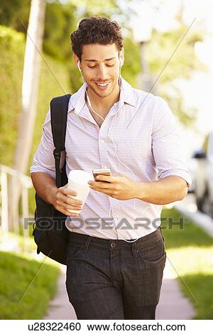 Man Walking Along Street To Work Listening To Music View Large Photo Image Stock Image - Man Walking Along Street To Work Listening To Music. Fotosearch