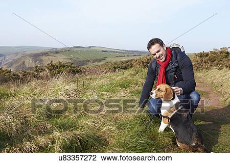 Man With Dog Walking Along Coastal Path View Large Photo Image Stock Image - Man With Dog Walking Along Coastal Path. Fotosearch