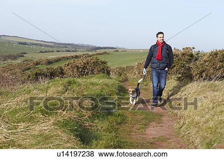 Man With Dog Walking Along Coastal Path View Large Photo Image Stock Photo - Man With Dog Walking Along Coastal Path. Fotosearch