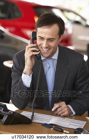 Man working in car showroom View Large Photo Image Stock Image - Man working in car showroom. Fotosearch