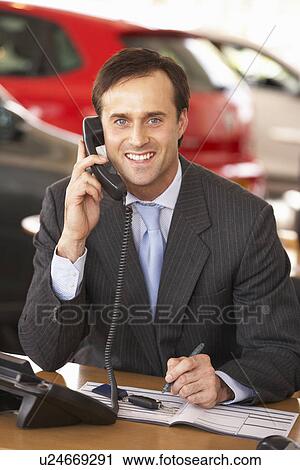 Man working in car showroom View Large Photo Image Stock Image - Man working in car showroom. Fotosearch