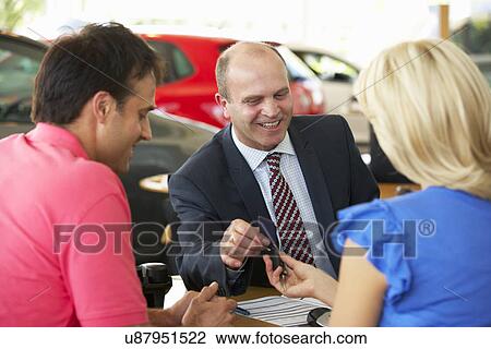 Man working in car showroom View Large Photo Image Stock Image - Man working in car showroom. Fotosearch