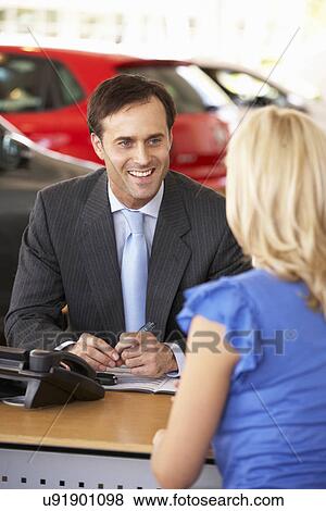 Man working in car showroom View Large Photo Image Stock Photo - Man working in car showroom. Fotosearch