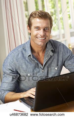 Stock Image - Man working in home office. Fotosearch