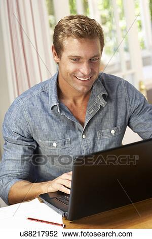 Stock Image - Man working in home office. Fotosearch