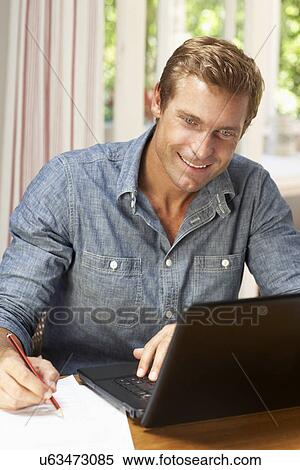 Man working in home office View Large Photo Image Stock Photography - Man working in home office. Fotosearch