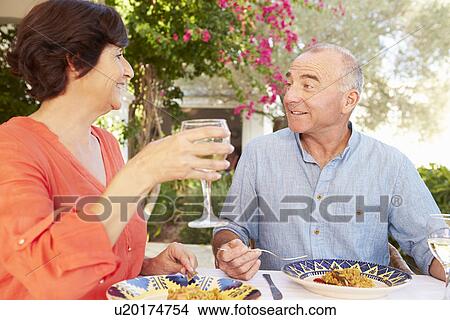 Mature Hispanic Couple Enjoying Outdoor Meal At Home View Large Photo Image Picture - Mature Hispanic Couple Enjoying Outdoor Meal At Home . Fotosearch