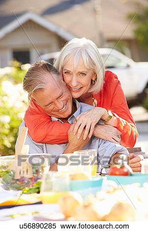 Mature Romantic Couple Enjoying Outdoor Meal In Garden View Large Photo Image Stock Photography - Mature Romantic Couple Enjoying Outdoor Meal In Garden. Fotosearch