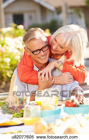 Mature Romantic Couple Enjoying Outdoor Meal In Garden View Large Photo Image Stock Photography - Mature Romantic Couple Enjoying Outdoor Meal In Garden. Fotosearch