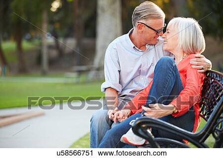 Mature Romantic Couple Sitting On Park Bench Together View Large Photo Image Stock Image - Mature Romantic Couple Sitting On Park Bench Together. Fotosearch