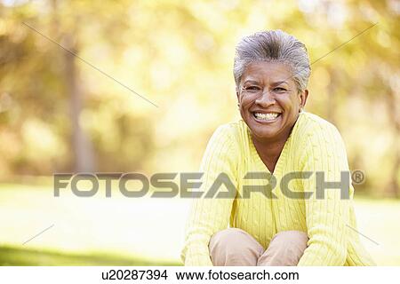 Mature Woman Relaxing In Autumn Landscape View Large Photo Image Picture - Mature Woman Relaxing In Autumn Landscape. Fotosearch