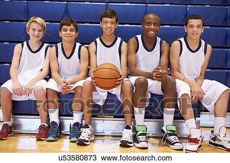 Stock Image - Members Of Male High School Basketball Team On Bench. Fotosearch