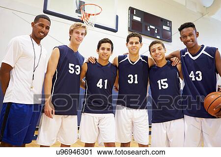 Stock Image - Members Of Male High School Basketball Team With Coach. Fotosearch
