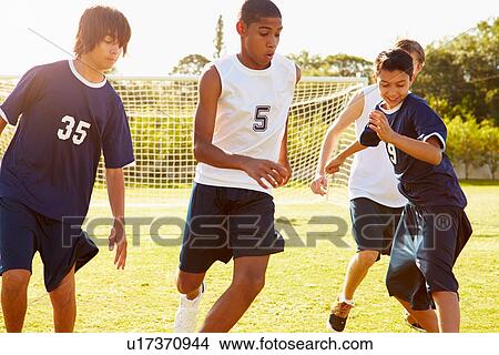 Picture - Members Of Male High School Soccer Playing Match. Fotosearch