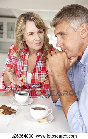 Stock Image - Mid age couple arguing at home. Fotosearch