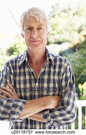 Mid age man in garden View Large Photo Image Stock Photo - Mid age man in garden. Fotosearch