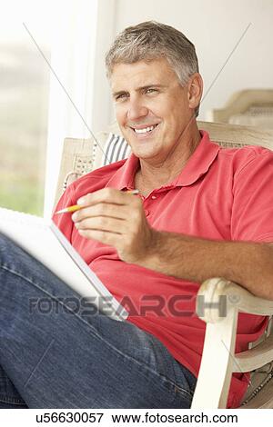 Mid age man sketching View Large Photo Image Stock Photo - Mid age man sketching. Fotosearch