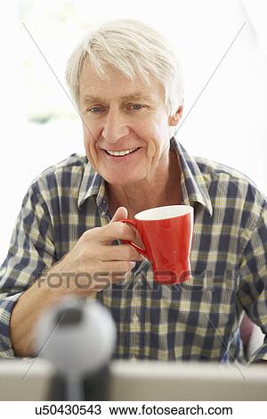 Mid age man using skype View Large Photo Image Stock Image - Mid age man using skype. Fotosearch