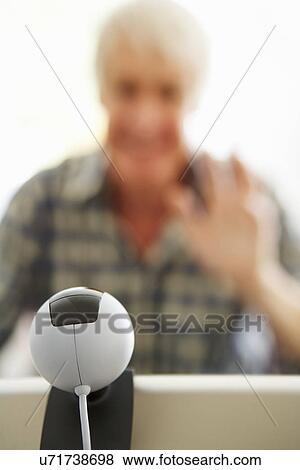 Mid age man using skype View Large Photo Image Stock Photo - Mid age man using skype. Fotosearch