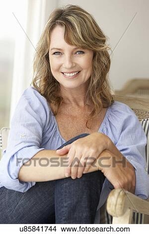 Mid age woman at home View Large Photo Image Picture - Mid age woman at home. Fotosearch